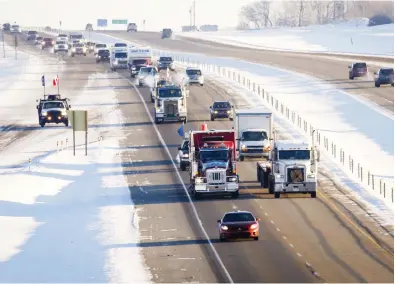  ?? JEFF MCINTOSH / THE CANADIAN PRESS ?? The “United We Roll” convoy of tractor-trailers, at top, rolls down the highway near Red Deer, Alta., on Thursday, en route to Ottawa to draw attention to the lack of support for the energy sector and pipelines. Brad Schell, right, seen south of Calgary earlier in the week, says he will be joining the convoy on its journey to Ontario.