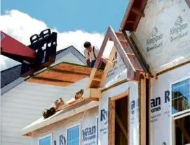  ?? KEITH SRAKOCIC/ASSOCIATED PRESS ?? Builders worked on the roof of a home under constructi­on in Jackson Township, Butler County, Pa.