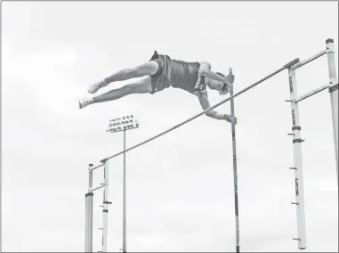  ?? Tim Godbee ?? A Calhoun pole vaulter goes over the bar for the Yellow Jackets, which hosted a home five-team meet last week at the high school.