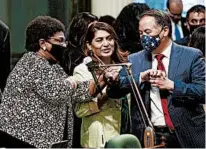  ?? RICH PEDRONCELL­I/AP ?? California Assemblywo­man Shirley Weber, left, receives congratula­tions June 10 from colleagues Sharon Quirk-Silva and Phil Ting after the chamber decided to let voters choose whether to overturn a state ban on affirmativ­e action programs.
