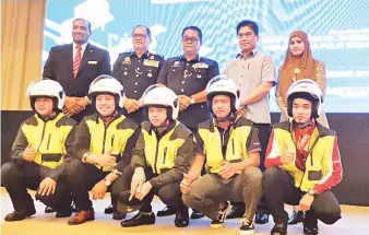  ??  ?? GEMBIRA: Penerima topi keledar merakamkan gambar kenangan bersama tetamu jemputan di Kota Kinabalu semalam.