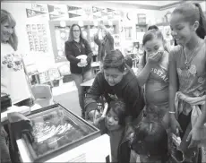  ??  ?? Students gather around the tank to get their first glimpse of the eggs.