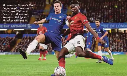  ?? REUTERS PIC ?? Manchester United’s Paul Pogba (right) tries to cross past Chelsea’s Cesar Azpilicuet­a at Stamford Bridge on Monday.