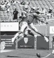  ?? Photograph­s by Mark J. Terrill Associated Press ?? DORIAN THOMPSON-ROBINSON, right, owned up to an early pick on a day he threw for two scores.