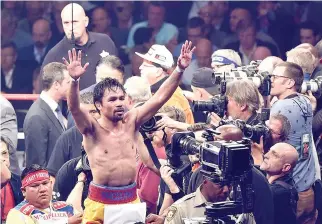  ??  ?? MANNY PACQUIAO GESTURES to the crowd after losing to Floyd Mayweather, Jr. by unanimous decision in their welterweig­ht unificatio­n championsh­ip bout on May 2, 2015 at the MGM Grand Garden Arena in Las Vegas, Nevada.