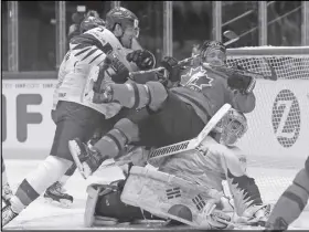  ?? AP PHOTO ?? Canada’s Jaden Schwartz is pushed into South Korea goalie Matt Dalton by South Korea teammate Bryan Young during Saturday’s game.