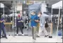  ?? Karen Warren / Houston Chronicle ?? Apple employees wait for customers at the front door in Houston on Wednesday.