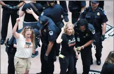  ?? OLIVIER DOULIERY/ABACA PRESS ?? Capitol Police arrest protesters opposed to Supreme Court Justice nominee Brett Kavanaugh in the atrium of the Hart Senate Office Building on Thursday in Washington, D.C.