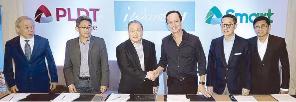  ??  ?? PLDT and Smart chair Manny V. Pangilinan and ABS-CBN chair Eugenio ‘Gabby’ Lopez III (third and fourth from left, respective­ly) lead the groundbrea­king partnershi­p of PLDT Home, Smart and ABS-CBN for iWant TV with (from left) lawyer Ray Espinosa, PLDT...