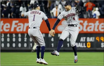 ?? MATT SLOCUM — THE ASSOCIATED PRESS ?? Astros shortstop Carlos Correa, left, and center fielder George Springer celebrate after Houston’s 4-1win against the Yankees in Game 3of the American League Championsh­ip Series Tuesday in New York.