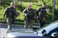  ?? JOSE LUIS MAGANA — ASSOCIATED PRESS ?? Heavily armed police officers patrol the area after multiple people were shot Thursday at The Capital Gazette newspaper in Annapolis, Md.