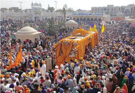  ?? — Reuters ?? Sikh devotees attend a religious procession to mark the 549th birth anniversar­y of Guru Nanak Dev Ji, founder of Sikhism, in Nankana Sahib near Lahore, Pakistan.