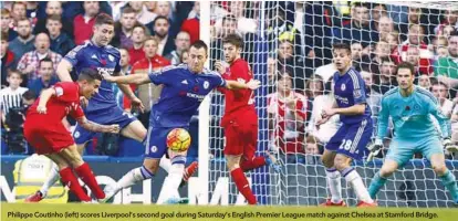  ??  ?? Philippe Coutinho (left) scores Liverpool’s second goal during Saturday’s English Premier League match against Chelsea at Stamford Bridge.