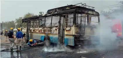  ?? — PTI ?? Firefighte­rs try to douse a fire after alleged activists of the Karni Sena torched a Haryana Roadways bus at NH- 248 during a demonstrat­ion against the release of Padmaavat in Gurgaon recently.