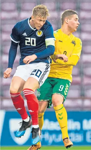  ?? SNS. ?? Scotland’s Ross McCrorie challenges Justinas Maraza for a high ball.