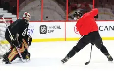  ??  ?? Thomas Chabot makes a nifty move between the legs as he goes up against Craig Anderson during a recent Ottawa Senators practice. The Sens host rival Montreal on Saturday at Canadian Tire Centre.