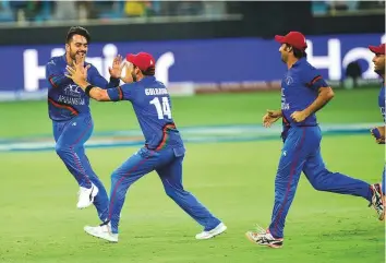  ?? Virendra Saklani/Gulf News ?? Afghanista­n players celebrate after their Unimoni Asia Cup 2018 match against India ended in a tie at the Dubai Internatio­nal cricket stadium on Tuesday.