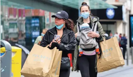  ??  ?? Shoppers with bags in Dublin City centre following the phased reopening of non-essential retail, with click-and