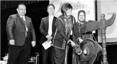  ??  ?? Jenifer beats the gong to mark the launch of the conference.