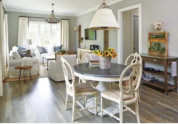  ??  ?? (top) The in-law suite feels like its own home. “We went more informal with a cottage flair for this space,” Lisa says. She used much of the clients’ in-laws’ original furniture, but added a slipcover to the sofa, textures and lighting for character and warmth.