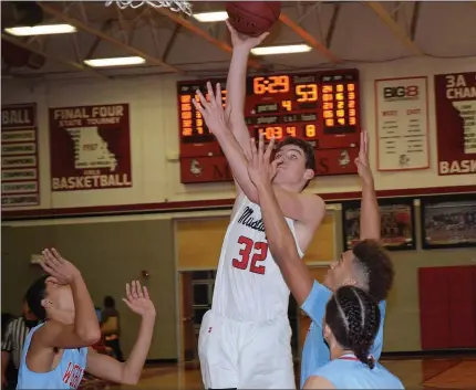  ?? RICK PECK/SPECIAL TO MCDONALD COUNTY PRESS ?? McDonald County’s Cade Smith scores two of his team-high 12 points during the Mustangs’ 77-45 loss on Dec. 11 at MCHS.