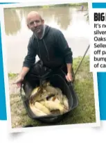  ??  ?? BIG HAULS
It’s not just silvers at The Oaks – Phil Sellers shows off part of a bumper net of carp.