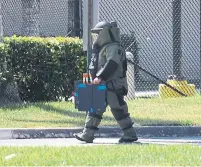  ?? JOE RAEDLE GETTY IMAGES ?? A member of a bomb squad investigat­es a suspicious package in Rep. Debbie Wasserman Schultz office in Sunrise, Fla.