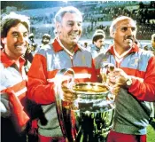  ??  ?? Ronnie Moran (above, right) with Roy Evans (left) and Joe Fagan holding the European Cup in 1984; and a few years earlier with Bob Paisley and Fagan: Moran was so dedicated to Liverpool that he played for the team on his wedding day