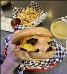  ?? JOSIE SEXTON, THE DENVER POST ?? The cheeseburg­er at Misfit Snackbar inside Middleman bar on Colfax.