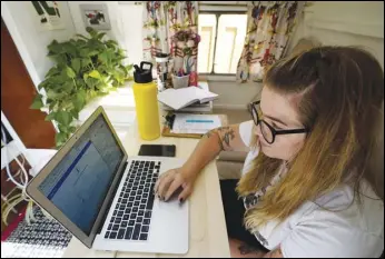  ?? ASSOCIATED PRESS ?? Kelly Mack works on her laptop to teach remotely from her early 1940s vintage camper/ trailer in her back yard at home in Evanston, Ill. Across the US, the pandemic has forced students to attend virtual school to prevent the spread of the Coronaviru­s. But the more we rely on technology, the bigger the consequenc­es when gadgets or Internet service let us down.