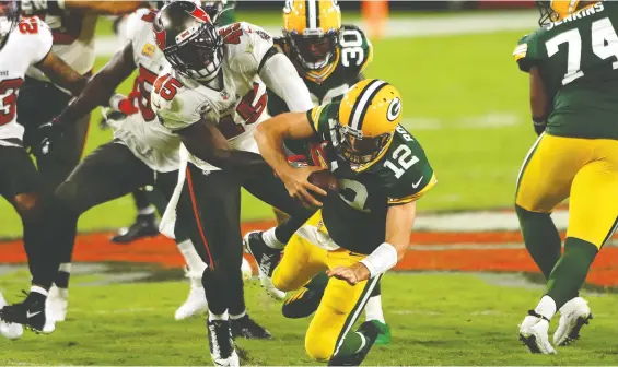  ?? MIKE EHRMANN/GETTY IMAGES FILES ?? Bucs linebacker Devin White sacks Packers QB Aaron Rodgers as Tampa Bay rallied from a 10-0 deficit to thump Green Bay at home back in October.