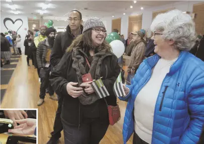  ?? AP PHOTOS ?? GOING GREEN: Margot Simpson, above right, and Diana Gladden wait in line to purchase marijuana at Harborside marijuana dispensary in Oakland yesterday. Bay State officials are keeping a close eye on California recreation­al pot sales.