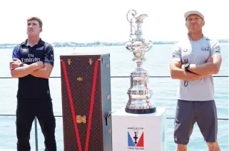  ??  ?? Oracle Team USA helmsman Jimmy Spithill, right, and Emirates Team New Zealand helmsman Peter Burling with the Auld Mug at Club AC in Hamilton, Bermuda, on Friday. (AFP)