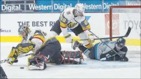  ?? Jeff Chiu The Associated Press ?? Marc-Andre Fleury covers a loose puck as Nick Holden (22) foils the offensive intentions of San Jose’s Kevin Labanc.