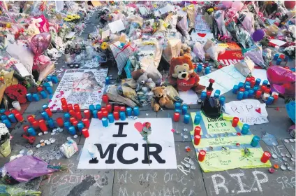  ?? Picture: Reuters ?? TRIBUTES. Flowers, messages and tokens are left in tribute to the victims of the attact on Manchester Arena, in central Manchester, England, yesterday.