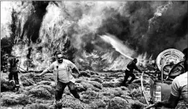  ?? ANGELOS TZORTZINIS/GETTY-AFP ?? Firefighte­rs scramble to put out flames Tuesday in Kineta, a town near Athens, Greece.