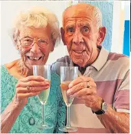  ??  ?? The couple toast a long life in their house, above