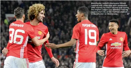  ??  ?? Manchester United’s Marouane Fellaini (second left) celebrates with teammates after scoring his side’s second goal during the English League Cup semifinal first leg against Hull City at Old Trafford stadium in Manchester on Wednesday. — AP