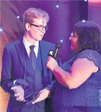  ??  ?? Ethan Connet-White, 16, from Bridgend, received the Outstandin­g Young Achiever Award at the Bridge FM Local Hero Awards. He is pictured with presenter Louise Apsee