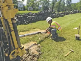  ?? BY SARA SCHONHARDT ?? Pipe layer Antonio Tolentino works to extend fiber optic cable to Rappahanno­ck's library, part of a project to bring high-speed Internet to the county's library and school district.