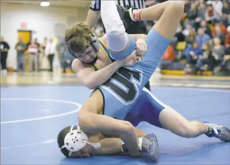  ?? Marc Billett/Tri-State Sports & News Service photos ?? Canon-McMillan’s Logan Macri, top, decisioned Louis Newell of Seneca Valley, 4-3, at 120 pounds. Macri, making his third appearance in a WPIAL final, scored his first title.