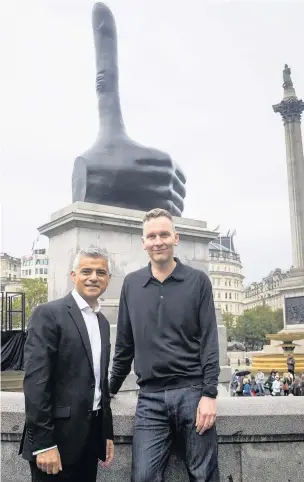  ??  ?? ●● David Shrigley and the Mayor of London Sadiq Khan in front of the new Fourth Plinth sculpture, ‘Really Good,’ in Trafalgar Square
