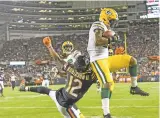  ?? DAVID BANKS/ASSOCIATED PRESS ?? The Packers’ Adrian Amos intercepts a pass Thursday against the Bears in Chicago. The Packers won 10-3.