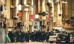  ??  ?? French special police forces secure the area as shots are exchanged in Saint-Denis, France, near Paris, November 18, 2015 during an operation to catch fugitives from Friday night’s deadly attacks in the French capital. (Reuters)