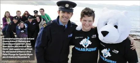  ??  ?? Garda and quintuple All-Ireland champ Aidan O’Mahony and Castleisla­nd swimmer Jonathan Kerins join mascot ‘Bear Chills’ and supporters at Fenit for the launch of Kerry’s first Polar Plunge for Special Olympics Ireland on December 9.