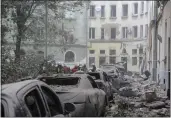  ?? MYKOLA TYS — THE ASSOCIATED PRESS ?? Emergency workers gather outside damaged buildings on Thursday as the search for victims continues following a Russian missile attack in Lviv, Ukraine.