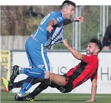  ??  ?? Spot of bother: Chris Hegarty concedes a penalty by chopping down Eoin Bradley