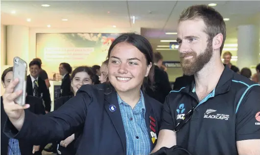  ?? PHOTO:PETER MCINTOSH ?? Otago Girls’ High School pupil Shakirah Stephen (16) takes a selfie with Kane Williamson as the New Zealand and Australian cricket teams arrive at the Dunedin Airport on Tuesday.