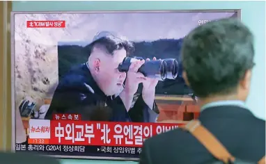  ?? PICTURE: AP ?? EYES ON THE PRIZE: A man walks by a TV screen in Seoul showing a news programme reporting about North Korea’s missile firing, with an image of North Korean leader Kim Jong-un. The missile reportedly has the range to hit North America.