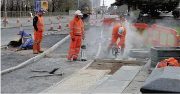  ??  ?? Refinement­s Workmen installed the cycle lanes in April but were sent back last week to “refine the scheme”